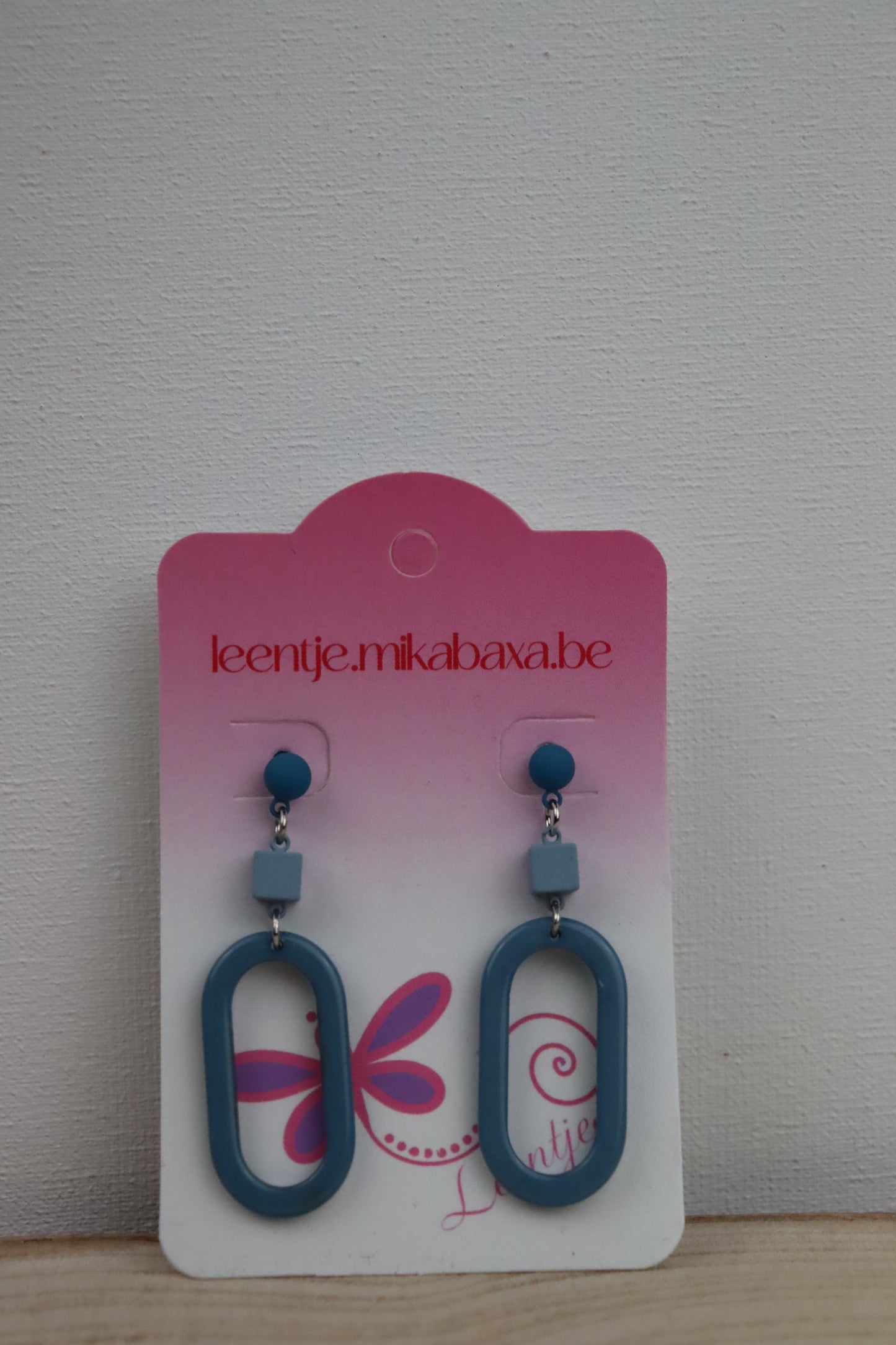 Donker teal oorknopjes met lente blauwe kubus en lente blauwe hanger