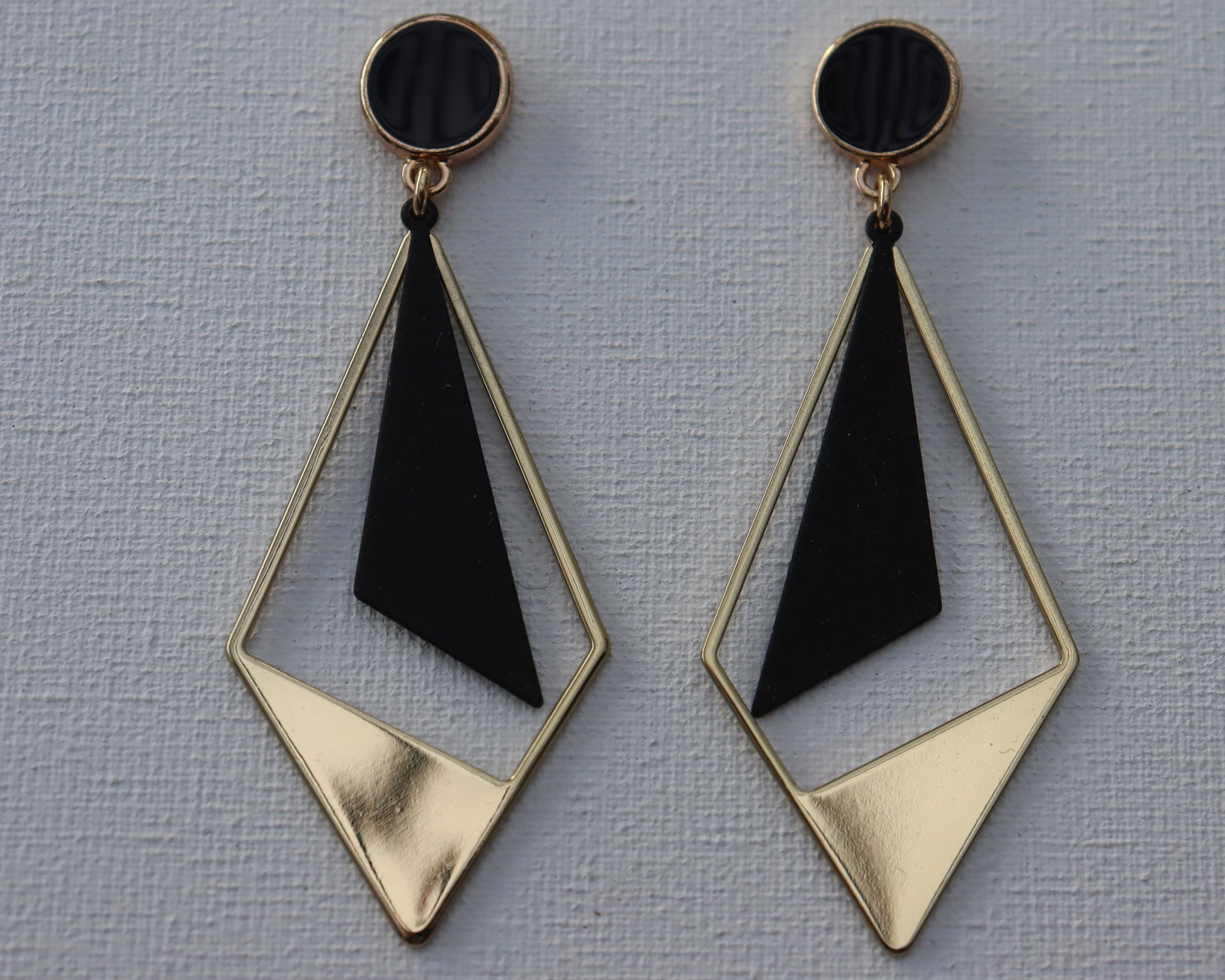 Goudkleurige zwarte stekertjes met goudkleurige half open ruit en zwarte driehoekhanger